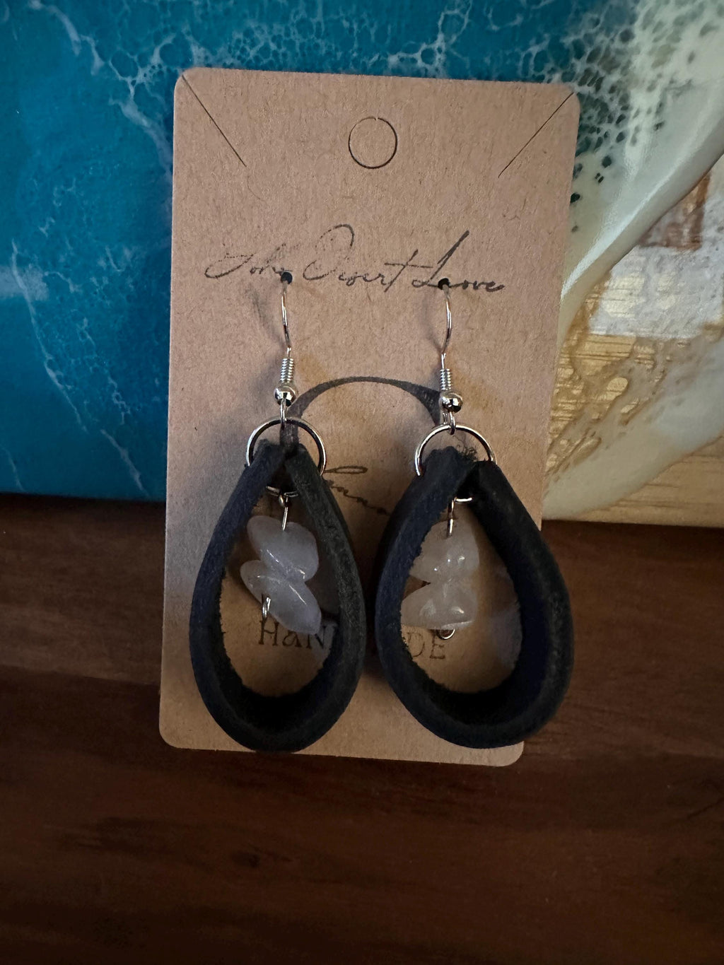 Rose Quartz surrounded in Black Leather with silver plated hooks