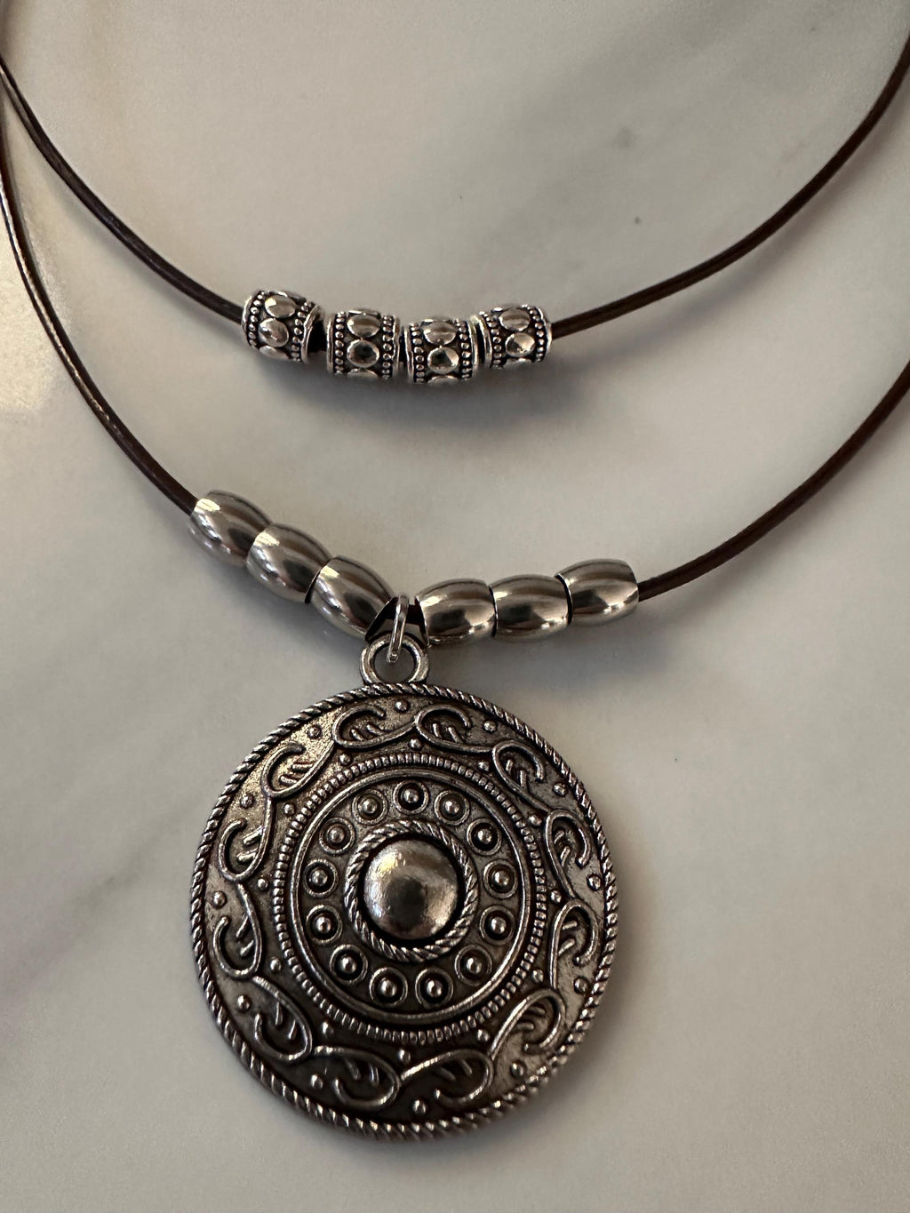 Antique Silver Round Pendant with Stainless Steel Beads on a double layered leather cord